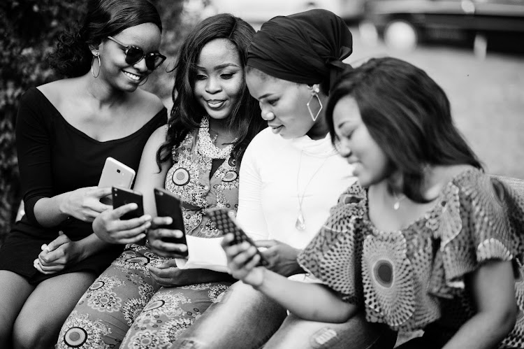 African women chat on a bench