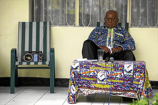 Former prime minister Étienne Tshisekedi listens to radio reports on results in the Democratic Republic of Congo’s 2011 election.