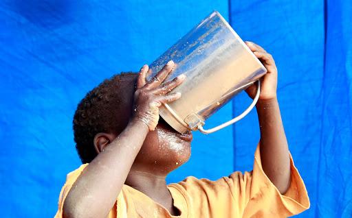 A newly arrived refugee child drinks inside their tent in Baley settlement near the Ifo extension refugee camp in Dadaab, near the Kenya-Somalia border, in Garissa County, Kenya July 27, 2011.