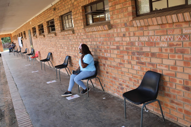 A member of the IEC waits for voters at Emjindini Secondary School in Barberton, Mpumalanga during the municipal elections on Monday.