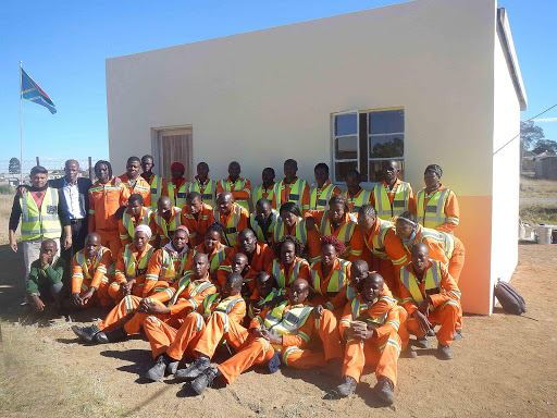 SOLID FOUNDATION: Triamic Construction site agent Gerald Peters, left, Zwelakhe JSS principal Zolile Mthetho and the school’s representative council of pupils president Sipho Petse together with 36 villagers from around Libode in front of the classroom they built Picture: SIKHO NTSHOBANE