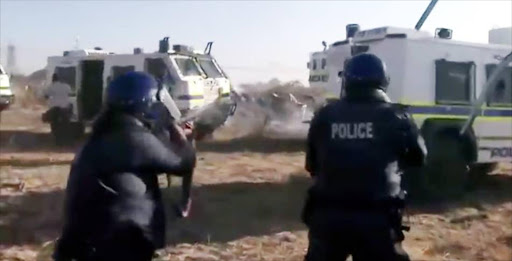 A scene from the documentary 'Miners Shot Down', showing the massacre of striking miners at Marikana by police in 2012.