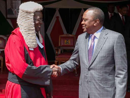 President Uhuru Kenyatta congratulates the newly-sworn-in Chief Justice David Maraga at State House. /PSCU
