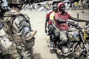 A French soldier of the Sangaris contingent mans a checkpoint in the formerly Muslim PK12 district of Bangui, Central African Republic, yesterday.  
       France sent troops six months ago to its former colony to help an African force stem sectarian bloodletting in the 
       impoverished, majority Christian country. CAR 
       has been struggling to restore security in the face of relentless 
       attacks between Christian vigilante groups and mostly Muslim ex-Seleka rebels who seized control in a coup last year but were forced from power in January 
      PHOTO:  MARCO LONGARI/AFP