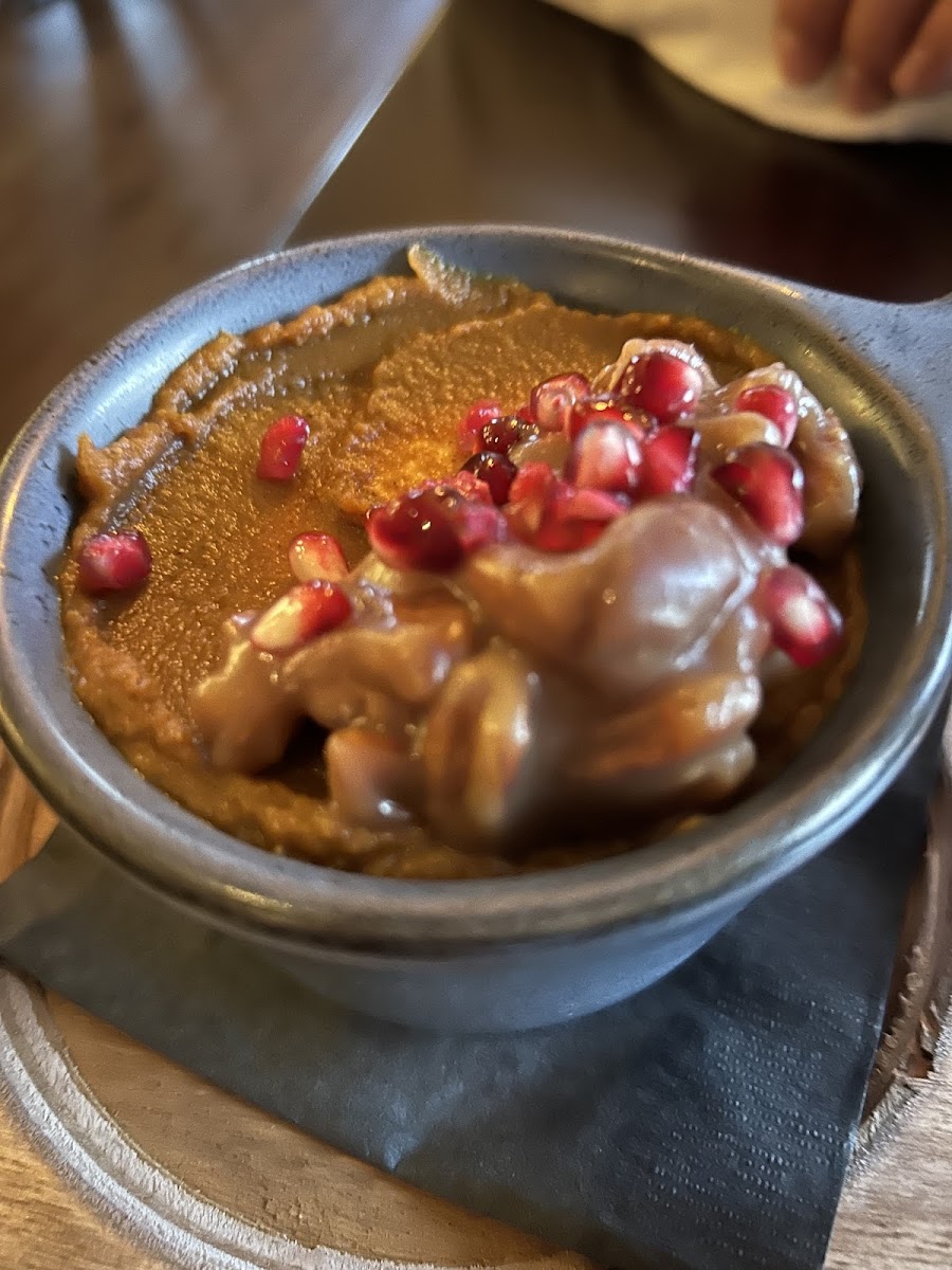 GF pumpkin cheesecake with pomegranates sprinkled on top.