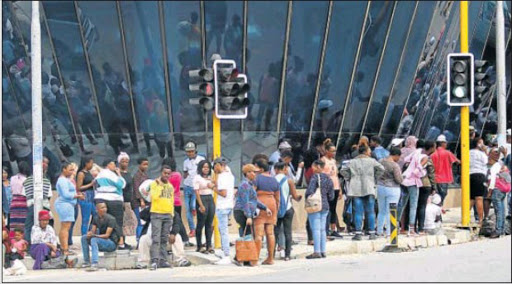 SINKING FEELING: Many people have spent frustrating hours in the queue that snakes daily outside the East London Home Affairs building in Fleet Street. Picture: MICHAEL PINYANA
