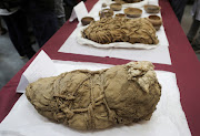 Mummified bodies wrapped in textiles from the pre-Incan Cajamarquilla archaeological site and believed to be between 800 and 1,200 years old are exhibited at the Universidad Nacional Mayor de San Marcos, in Lima, Peru February 22, 2022. 