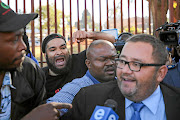 Members of the Black First Land First  heckle AfriForum chief executive officer Kallie Kriel. 