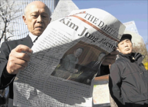 TRAGIC NEWS : A man reads an extra edition of a newspaper reporting the death of North Korean leader Kim Jong-il in Tokyo yesterday . He died on a train trip, state television reported yesterday.