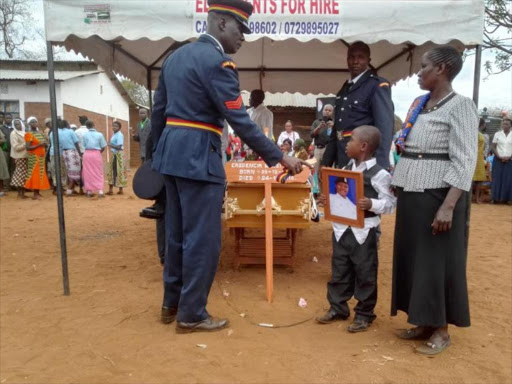 Police officers prepare to carry the casket of the late corporal Caudencia Wausi during her send off at Wikililye village, Kibwezi East, Makueni County on Saturday September 3, 2016 /COURTESY