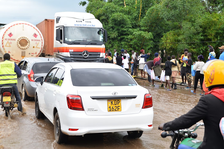 Water spills onto a road at Nyando bridge in Kisumu after Nyando River broke its banks affecting nearby homes and shops on May 4, 2024.