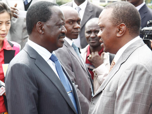Raila Odinga chats with President Uhuru Kenyatta.Photo/FILE