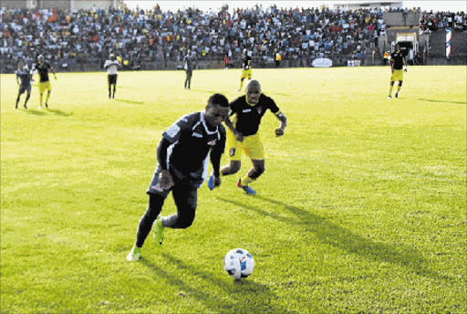 Mthatha Bucks captain Thabiso Mokoena closes down a Real Kings FC player in their 2-1 win at the Mthatha Stadium on Saturday. Picture: MKHULULI NDAMASE