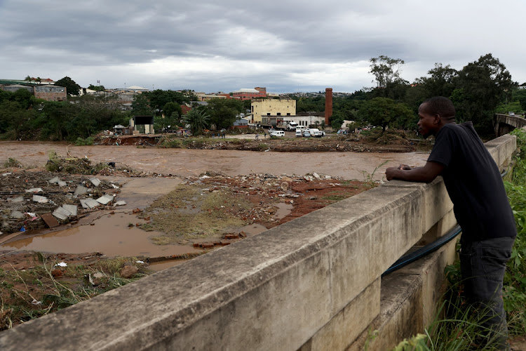 A man looks at the site where Ally's Sand company was washed away in Tongaat.