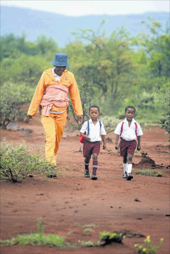 LEARNING EARLY: Semakaleng Serite accompanies her daughter Boitshwarelo and her cousin Tshiamo Motingwa to school.