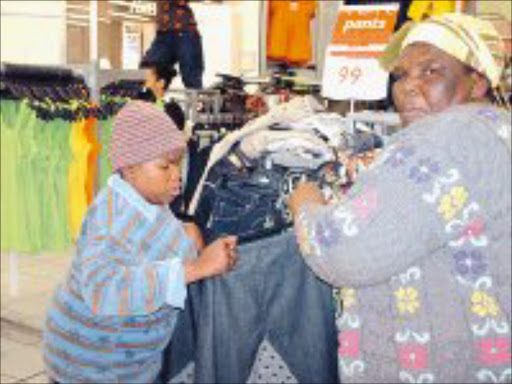 MY DAY: Mpho Mathibela and her mother, Sophie, check the size of the skirt Mpho will wear on her 21st birthday. Pic. Lindi Obose. 03/10/07. © Sowetan.