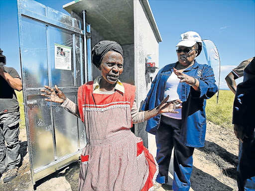 FLUSH UP: Nozipho Ntintili from California village near Ngqamakwe receives her new Siyenza toilet from ADM Mayor Nomasikizi Konza in this picture from our file Picture: MARK ANDREWS