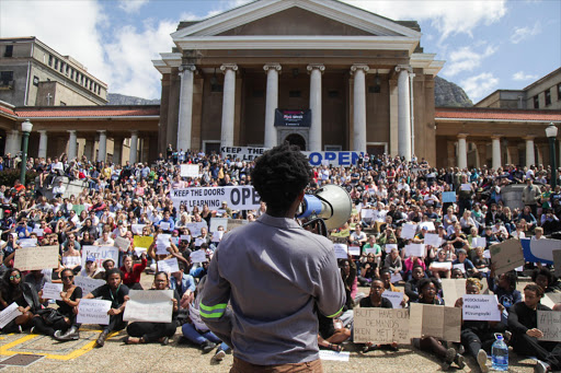 A #FeesMustFall protester addresses thousands of UCT students and staff who want the institution to reopen on Monday.