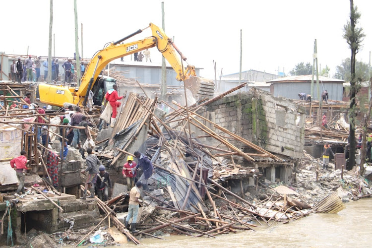 A bulldozer brings down several structures at Mkuru kwa Reuben on May 6, 2024