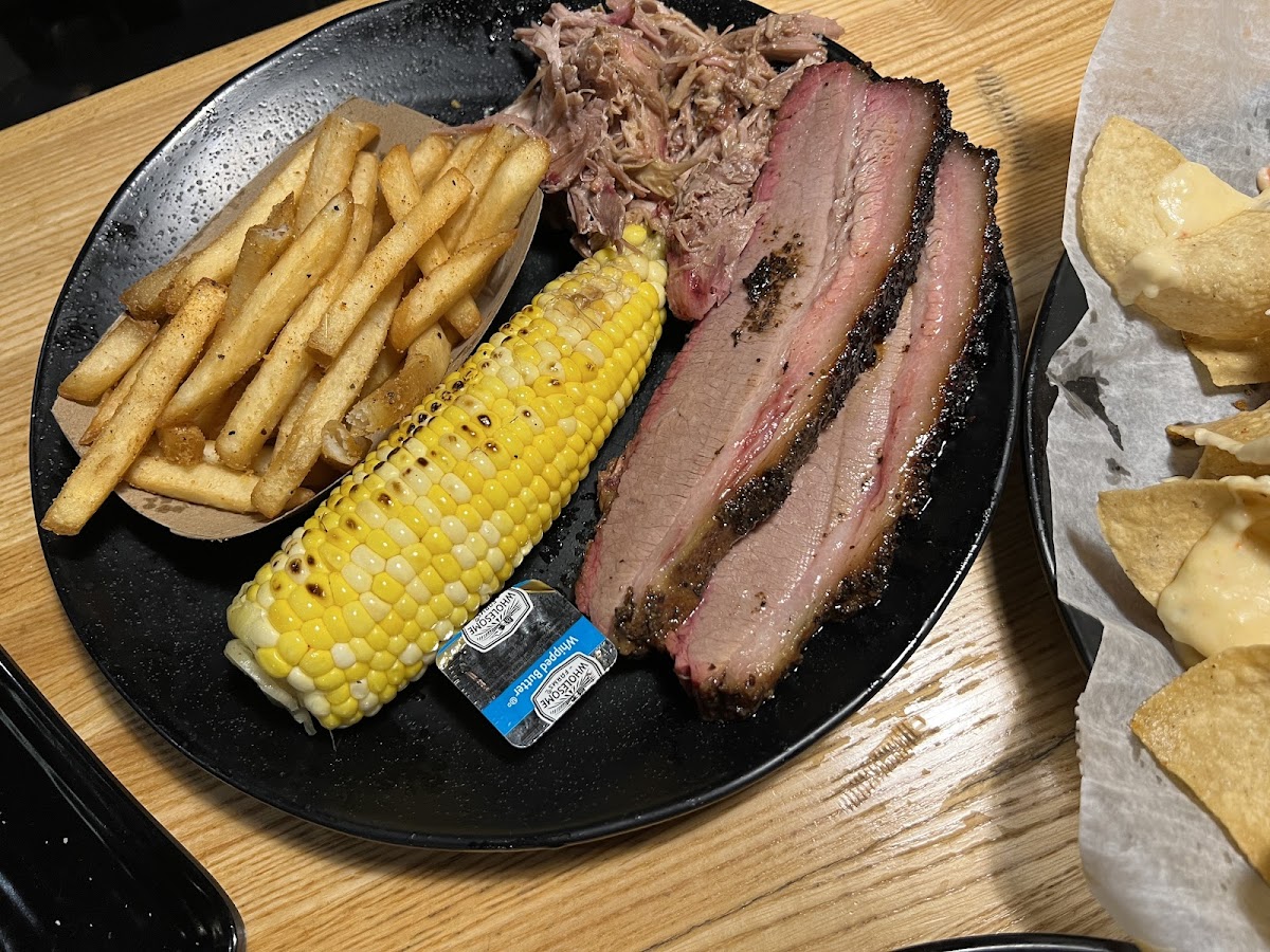 Pulled pork and brisket, with a side of corn and french fries