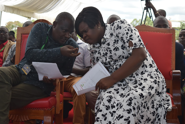 ODM national chairman John Mbadi consults with Homa Bay Governor Gladys Wanga during education symposium in Ndhiwa constituency on April 5,2024