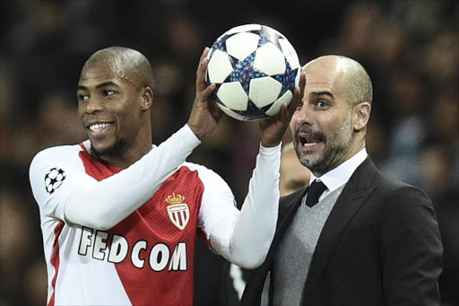 Manchester City's Spanish manager Pep Guardiola (R) reacts with Monaco's French defender Djibril Sidibe (L) during the UEFA Champions League Round of 16 first-leg football match between Manchester City and Monaco at the Etihad Stadium in Manchester, north west England on February 21, 2017.