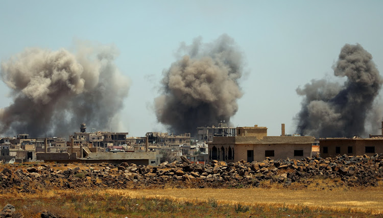 Smoke rises from al-Harak town, as seen from Deraa countryside, Syria, on June 25 2018.