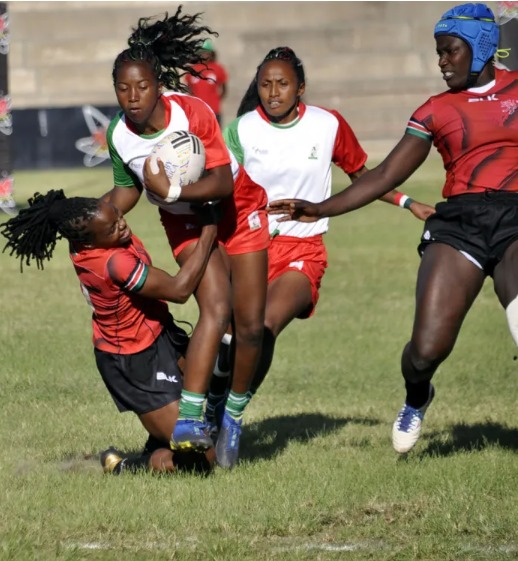 Siniada Mokaya tackles a Malagasy player as Enid Ouma looks on during their Rugby Africa Women's tournament in Antanarivo