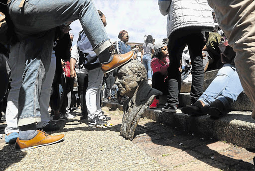 University of Cape Town students vandalise a statue on the campus during their Fees Must Fall protest.