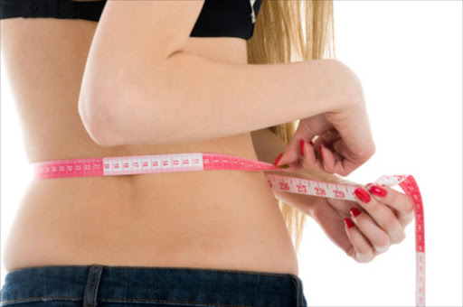 Woman measuring her waist. File photo.