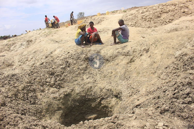 Women from Ndigiria village, Kilifi County near a dry water pan due to prolonged drought.