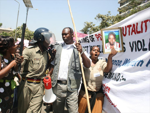 A file photo of a police officer confronting demonstrators claiming to be victims of 2007/08 Post Election Violence at the former Prime Minister's office. /MONICAH MWANGI