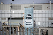A poster featuring a Range Rover Evoque outside Jaguar Land Rover's assembly plant in Halewood, UK. This and two other UK-based plants are in danger of running short of plants due to the coronavirus.