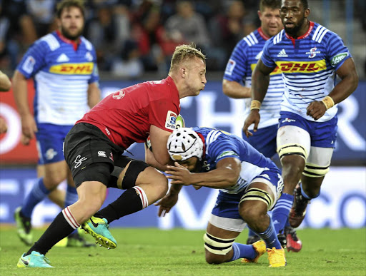 ON BENDED KNEE: Lions loose-forward Johan Ackermann barges into his tackler during Saturday's intense encounter with the Stormers at Newlands.