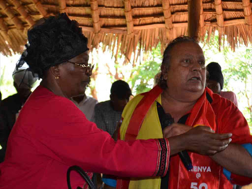 Taveta MP Naomi Shaban snatches a microphone from Zahid Din during the stormy meeting in Voi, December 13, 2016. /RAPHAEL MWADIME