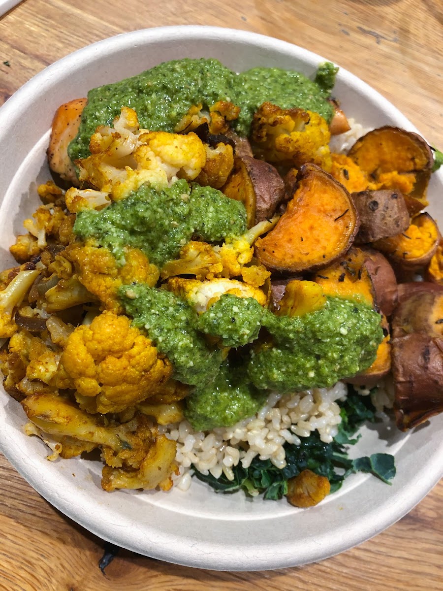 Kale & rice base with salmon, cauliflower, sweet potatoes and pesto.