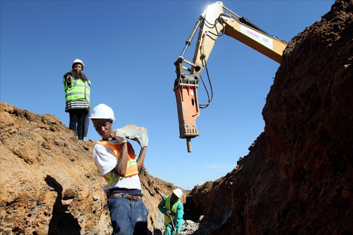 May 25, 2017. Patricia Gumbi, top left, directs Lehlohonolo Raithule who was hired with 47 other people after their protest over jobs led to the grounding of a housing project in De Deur, south of Joburg. Photo Sandile Ndlovu-