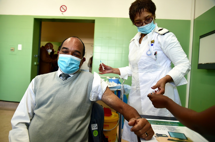 A nurse administers the Covid-19 vaccine to a man at the provincial hospital in Gqeberha. Picture: EUGENE COETZEE