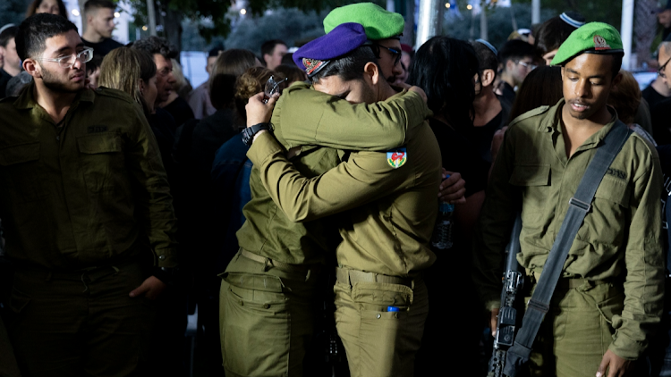 Soldiers mourn during a funeral for IDF soldier Sergeant Michael Ruzal Killed in a rocket attack in Southern Israel on May 6, 2024 in Rishon LeZion, Israel.