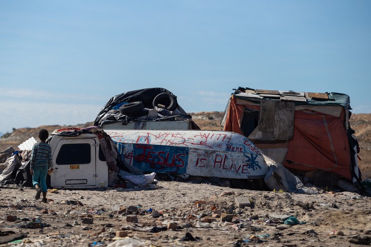 The dwelling number MS2 can be seen as it was marked by the City of Cape Town. Five families live here, between a recycling centre and a pig farm on vacant land in Vrygrond.