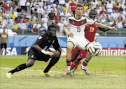 STEPPING UP: Ghana's goalkeeper Fatau Dauda, left, defends the goal area as Germany's Thomas Mueller and Ghana's Jonathan Mensah fight for the ball during their World Cup match at the Castelao Arena in Fortaleza
      Photo: Laszlo Balogh/REUTERS