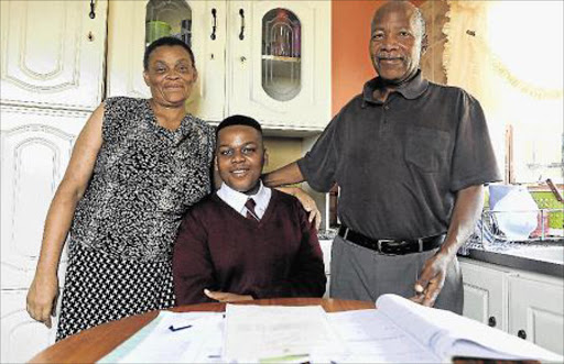 Njabulo Khumalo from Nyameko High School in Zone 8, Mdantsane, finished matric at 16, with five distinctions. He is seen here with his proud mother, Phelisa, and father Roy l