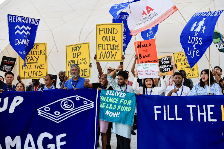 Activists hold placards and shout slogans during a protest, at the United Nations Climate Change Conference COP28 in Dubai, United Arab Emirates, December 6, 2023. Picture: THAIER AL-SUDANI