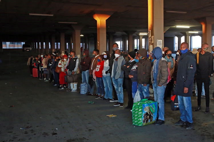 Alexandra residents seen in queues at Pan African taxi rank as most of them go to work for the first time.