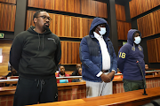 Fidelis Moema and his co-accused Trevor Machimana and metro cop Lebogang Sigubudu appear in the Palm Ridge specialised commercial crimes court.