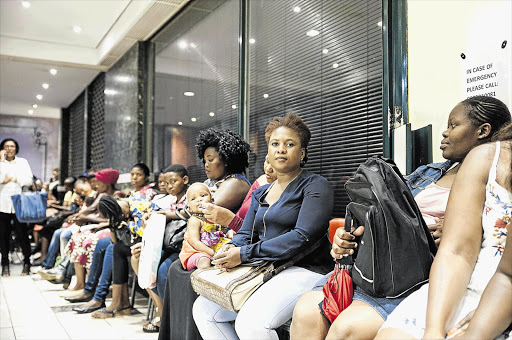 LOSING HOPE: Lerato Motloung, in the navy top, waits at the Gauteng education department to get her daughter placed in school