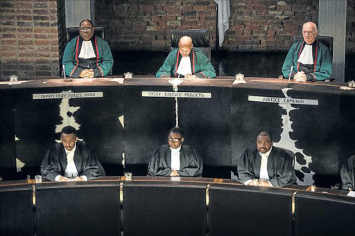 RATIONAL BASIS: Chief Justice Mogoeng Mogoeng, top centre, speaks at the Constitutional Court of South Africa during judgment on an application to allow a secret ballot in parliament after calling for a vote of no-confidence in President Jacob Zuma Picture: AFP