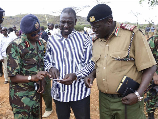 DP William Ruto talks to security officials during his visit to Kerio valley, February 24, 2017. /DPPS
