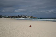 A single sunbather remains following the closure of Bondi Beach, in Sydney, March 21 2020, after thousands of peopled flocked there in recent days, defying social distancing orders to prevent the spread of the coronavirus. 