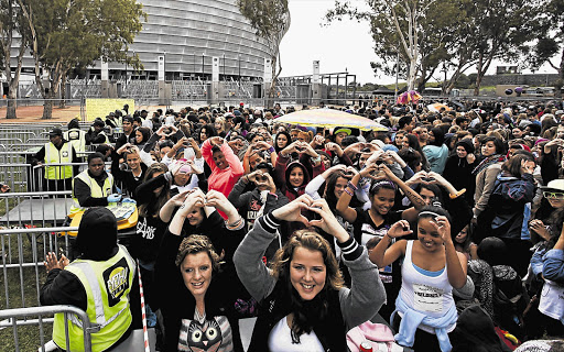 Fans of Canadian pop singer Justin Bieber, or 'Beliebers', at the Cape Town Stadium, yesterday. Many of his fans waited outside the stadium for a whole day or more. Bieber went on stage just before 9pm and got straight into 'All Around The World', followed by 'Take You' and 'Catching Feelings'. He also performed crowd favourites such as 'Never Say Never', 'Beauty and a Beat' and 'Baby'